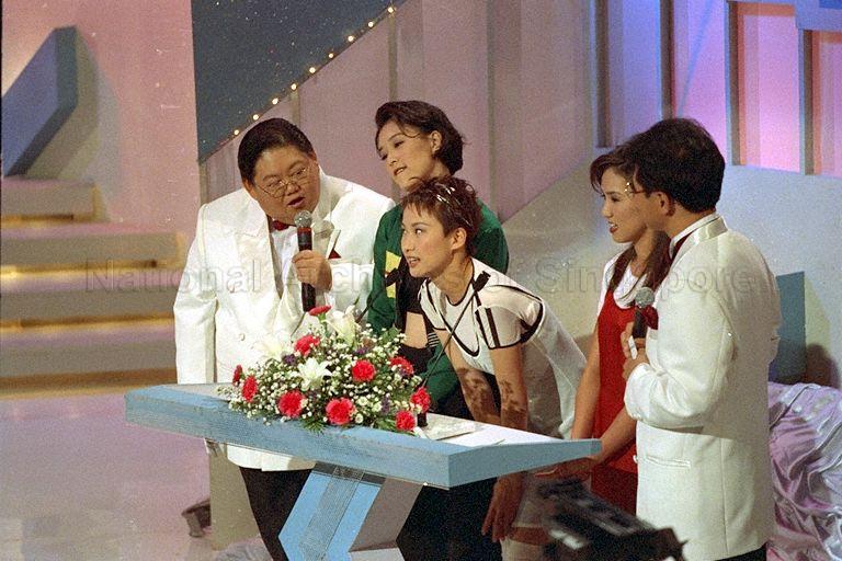 Show hosts Moses Lim and Jack Neo (shown from the side) hosting the National Kidney Foundation's 25th anniversary Hongkong Stars Charity Show, Singapore Broadcasting Corporation auditorium