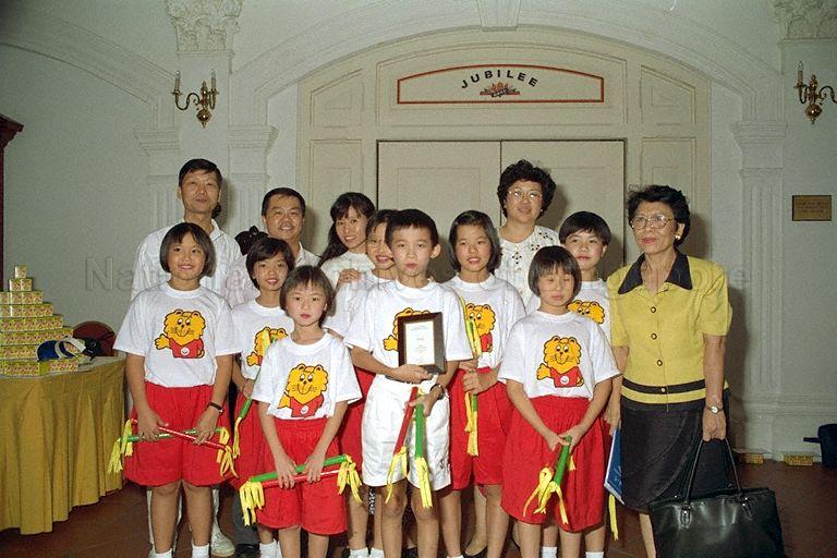 Pupils and teachers from Nanyang Primary School posing for group photograph after winning a gold medal for their performance at first courtesy skit contest for primary schools held at Jubilee Hall, Raffles Hotel