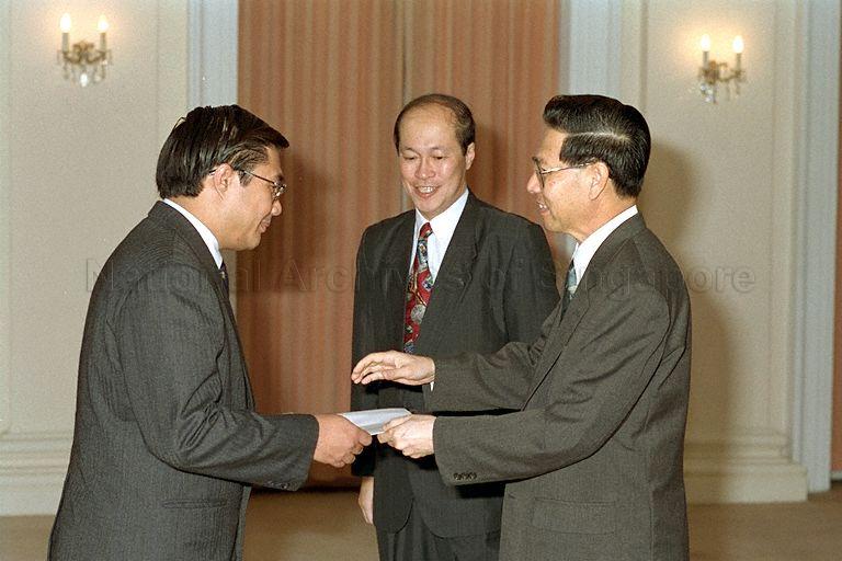 Nominated Member of Parliament (NMP) and law lecturer, associate professor Walter Woon receiving his instrument of appointment from President Ong Teng Cheong, witnessed by Speaker of Parliament Tan Soo Khoon in the Istana