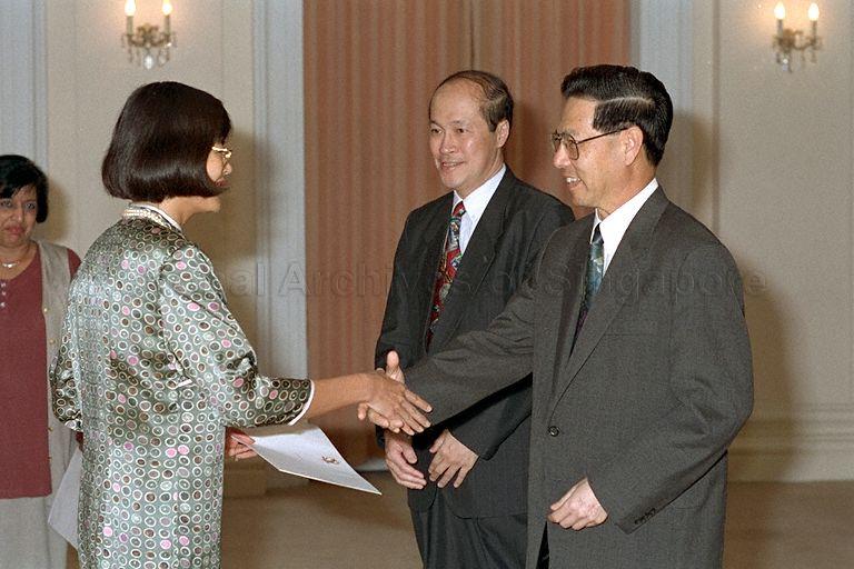 President Ong Teng Cheong congratulating Nominated Member of Parliament (NMP) and deputy director of the Institute of Policy Studies Dr Lee Tsao Yuan during an appointment ceremony witnessed by Speaker of Parliament Tan Soo Khoon in the Istana. In the background is NMP Dr Kanwaljit Soin (partially hidden).