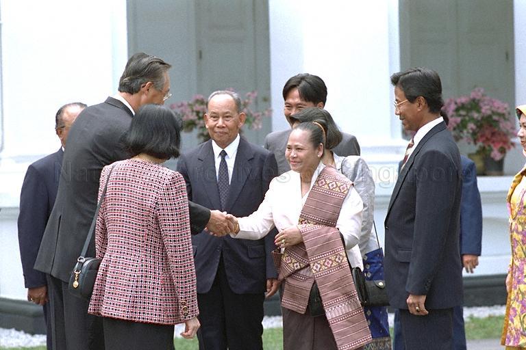 Prime Minister of Laos Khamtay Siphandone and wife Madam Thongvanh being greeted by Prime Minister Goh Chok Tong and Mrs Goh (both with back to camera) on arrival at Istana for ceremonial welcome. On the right is Minister of State for Education Sidek Saniff.