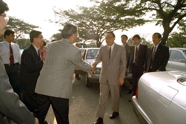 China's Communist Party propaganda chief Ding Guangen arriving for a visit of the Institute of East Asian Political Economy (IEAPE) at National University of Singapore.  Welcoming him is (back to camera) Professor John Wong, Director of IEAPE