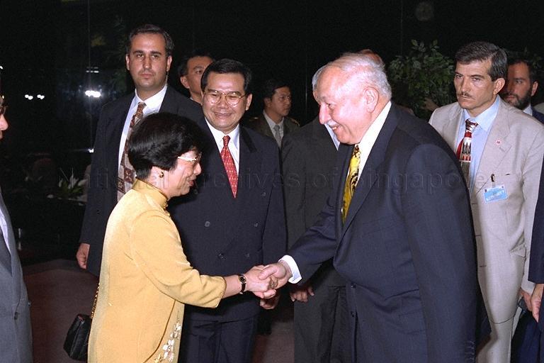 Senior Minister of State for Health and Education Dr Aline Wong greeting Prime Minister of Turkey Professor Dr Necmettin Erbakan at dinner hosted by Prime Minister Goh ChoK Tong at Mandarin Hotel. Looking on is Minister for Community Development and Minister-In-Charge of Muslim Affairs Abdullah Tarmugi.