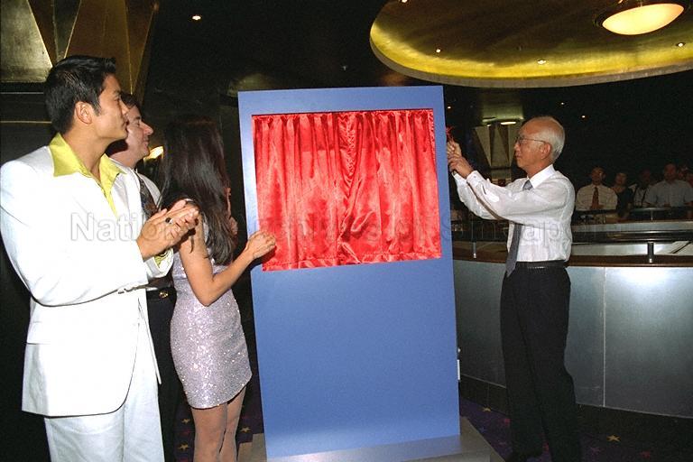 Founder of Golden Harvest Raymond Chow of Hong Kong unveiling commemorative plaque at Golden Village Marina, Marina Leisureplex, where the launch of Speak Mandarin Campaign is held. Guest of honour at the launch of Speak Mandarin Campaign was Deputy Prime Minister and Minister for Defence Dr Tony Tan Keng Yam.