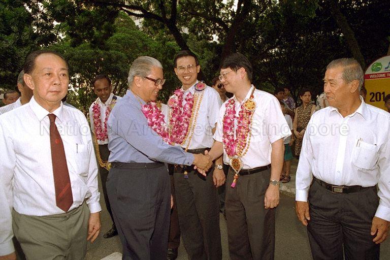 Official opening of Interim Upgrading Precinct Project "Admiralty Park" at Block 204 Marsiling Drive and Tree Planting by Deputy Prime Minister and Minister for Defence, and Member of Parliament (MP) for Sembawang Group Representative Constituency (GRC) Dr Tony Tan Keng Yam -- Dr Tan being greeted by fellow MP for Sembawang GRC Chin Tet Yung, upon arriving for the event