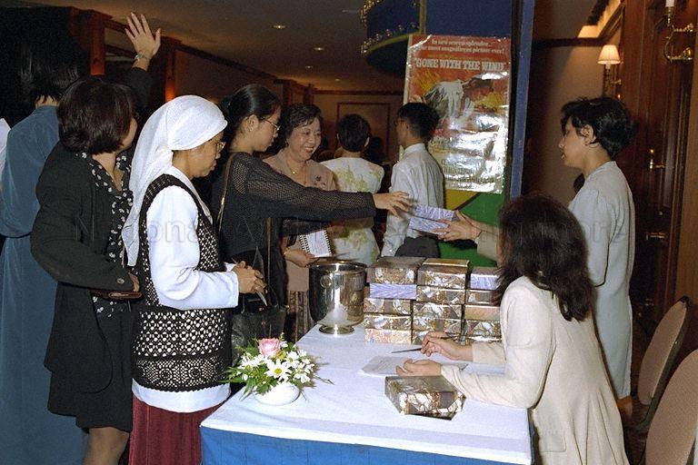 Guests receiving door gifts during Ministry of Information and the Arts Dinner and Dance at Orchard Road Hotel