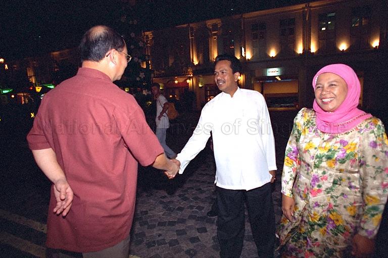 Outgoing Parliamentary Secretary to Ministry of Information and the Arts (MITA) Mohamad Maidin Packer Mohd being greeted by MITA Permanent Secretary Brigadier-General Tan Chin Tiong (back to camera) on arrival at Azizah's Restaurant, Albert Court, to attend farewell dinner hosted by Minister for Information and the Arts and Second Minister for Trade and Industry Brigadier-General George Yeo Yong-Boon. On the right is Mrs Mohamad Maidin.