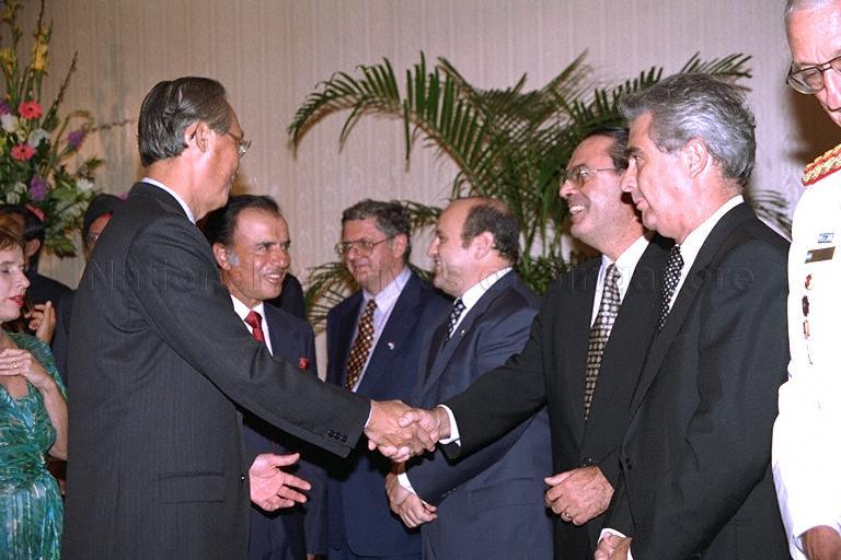 President of the Republic of Argentina Carlos S Menem introducing a member of his delegation to Prime Minister Goh Chok Tong at the dinner hosted at Raffles Hotel