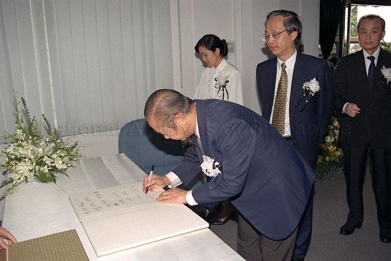 Mr Ho Kah Leong, former Senior Parliamentary Secretary to Ministry of the Environment, signing the condolence book for the late Chinese Premier Deng Xiaoping at Embassy of People's Republic of China, Dalvey Road, with Member of Parliament for Bukit Timah Group Representation Constituency (GRC) Dr Ong Chit Chung (centre) looking on