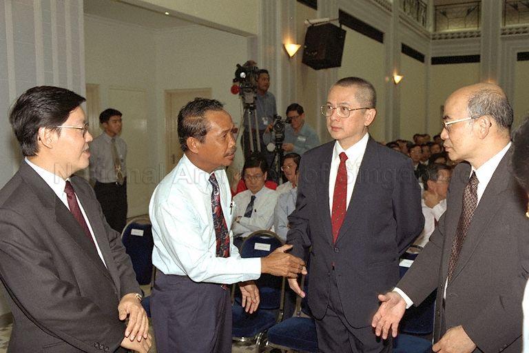 Senior Parliamentary Secretary to Ministry of Foreign Affairs Yatiman Yusof (second left) congratulates the two new mayors, Member of Parliament (MP) for Mountbatten Eugene Yap Giau Cheng (second right) and MP for Leng Kee Dr Ow Chin Hock (right), with Senior Parliamentary Secretary to Ministry of Defence and Ministry of National Development Matthias Yao Chih looking on during swearing-in ceremony of CDC mayors at People's Association (PA) auditorium
