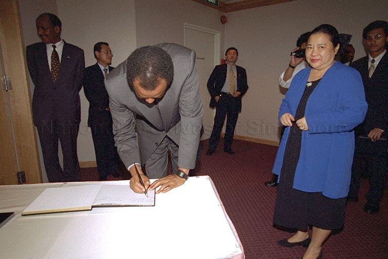 President Isaias Afwerki of Eritrea signing guest book on arrival at Singapore Tourist Promotion Board (STPB) for a visit. On the right is STPB Senior Director of Special Projects Mrs Pamelia Lee. The Eritrean President was in Singapore for a four-day visit, the first by a head of state of the East African country.