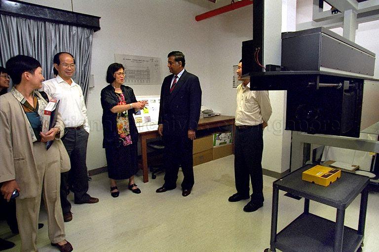 Director of National Archives of Singapore (NAS) Lily Tan and joined by Deputy Directors Pitt Kuan Wah (partially hidden) and Lim Guan Hock (second from left) briefing Joint Secretary of the Department of Culture in India's Ministry of Human Resource Department, S Sathyamoorthy during a guided tour of the NAS on 1 Canning Rise