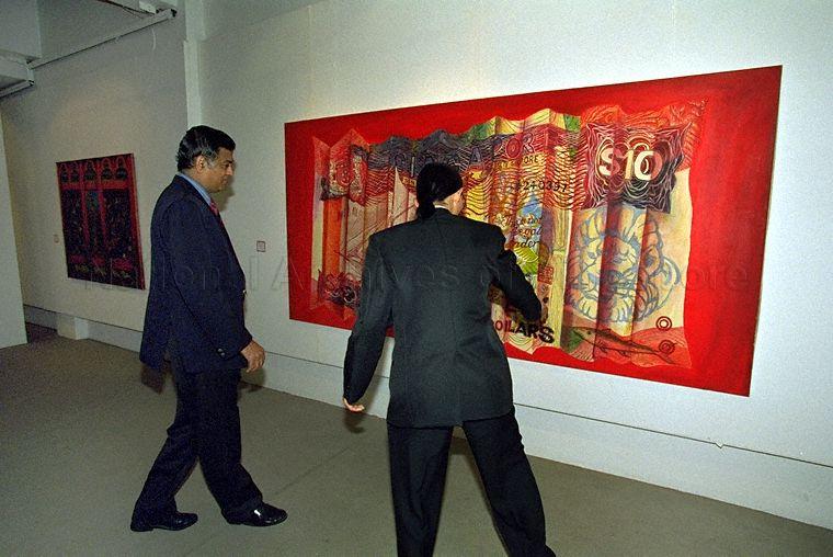 Artist Raymond Lau Poo Seng (right) briefing Joint Secretary of the Department of Culture in India's Ministry of Human Resource Development, S Sathyamoorthy during a guided tour of his second solo exhibition at The Substation on Armenian Street
