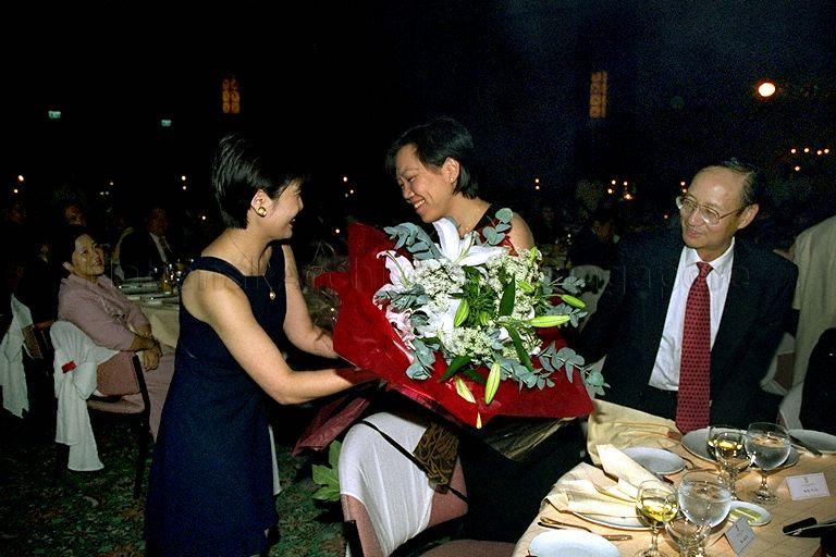 Wife of Minister for Health and the Environment Mrs Helen Yeo being presented with a bouquet of flowers at the opening of Merchant Court Hotel at 20 Merchant Road. Her husband, Yeo Cheow Tong is the Guest-of-Honour at the event.