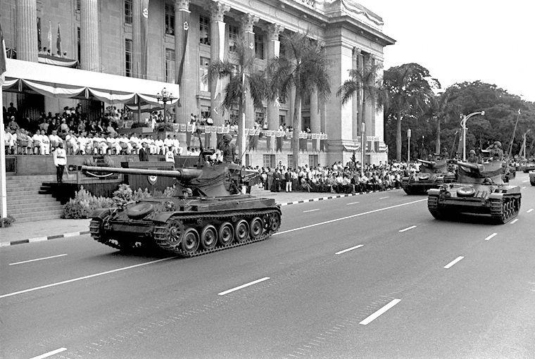 National Day Parade 1969 at the Padang - View of French-made AMX-13 tanks, part of the Singapore Armed Forces (SAF) mobile column, moving past City Hall. Vice President Wee Chong Jin and the cabinet are viewing on the steps of City Hall.