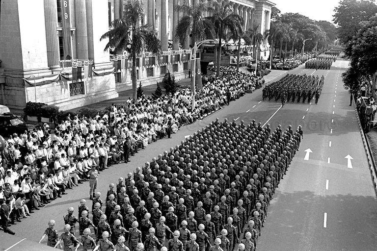 National Day Parade 1969 at the Padang -- View of Singapore Armed Forces (SAF) contingents marching past guests and spectators outside City Hall, along St Andrew's Road