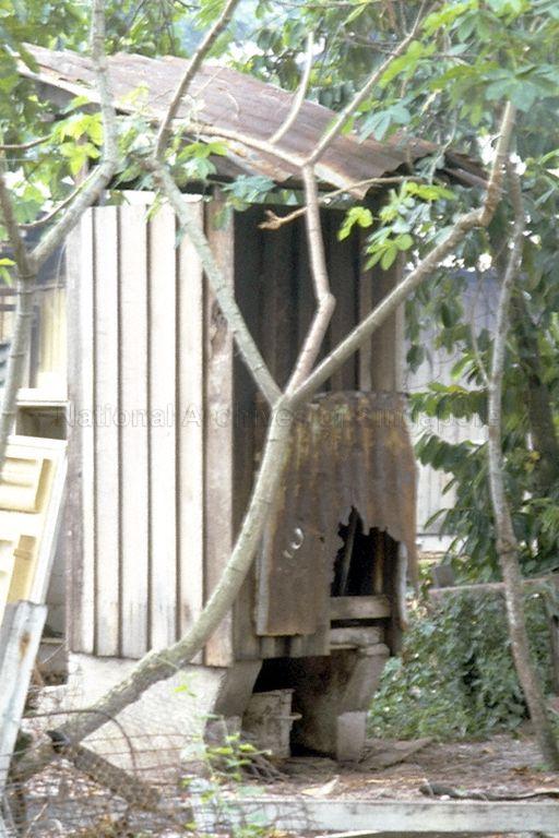 Rear of a latrine outhouse showing nightsoil bucket in position.