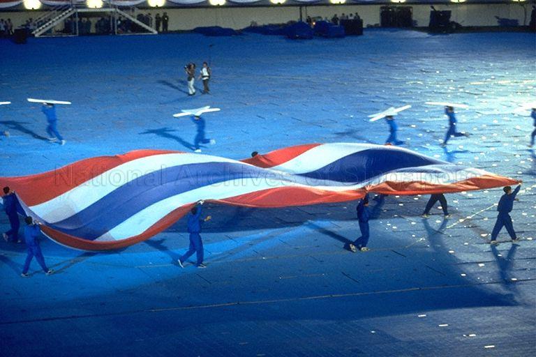 National Day Parade 1997 Full Dress Rehearsal at National Stadium -- Giant flag of Thailand displayed during performance by SAF Red Lions parachuting team