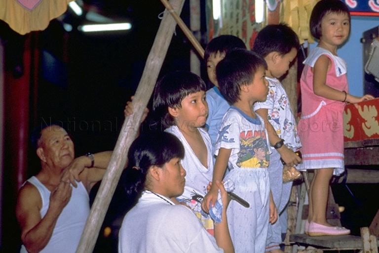 Spectators during a Chinese wayang (opera) performance