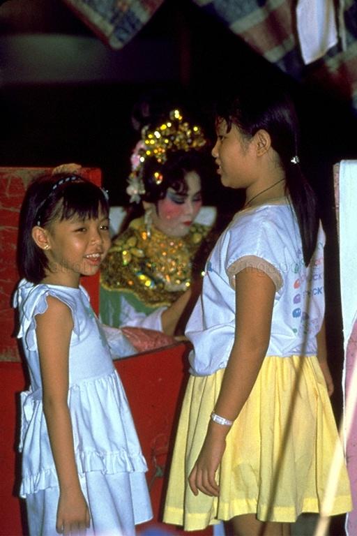 Children at the back stage during a Chinese wayang (opera) performance