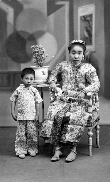 Studio portrait of a Straits Chinese lady and a young girl