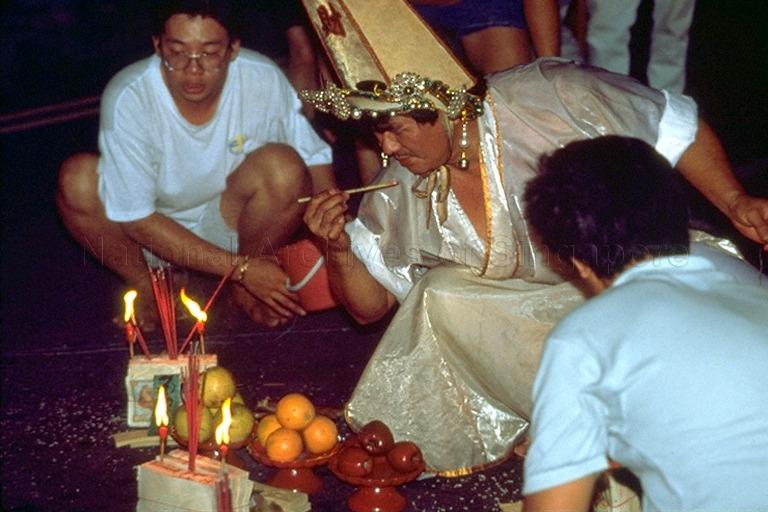 Medium (tangki) performing ritual at Taoist temple