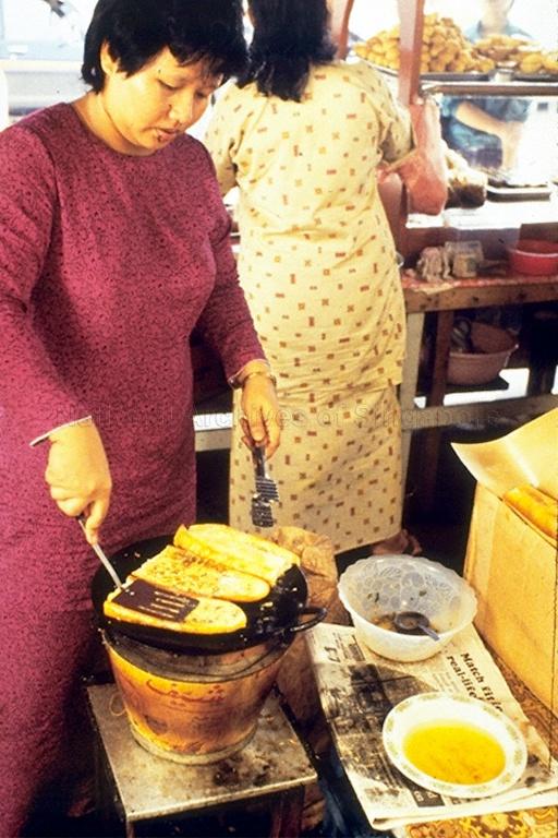 A Malay lady making Malay kueh (bite-sized snack and dessert foods)