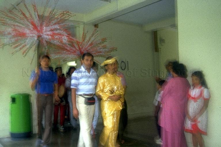 Arrival of bridegroom (in yellow) during Malay wedding held at void deck of Housing and Development (HDB) flat