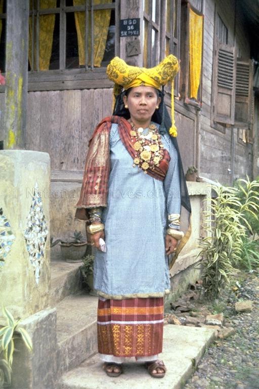 Minangkabau woman in traditional clothing and headdress formed in the shape of water buffalo horns