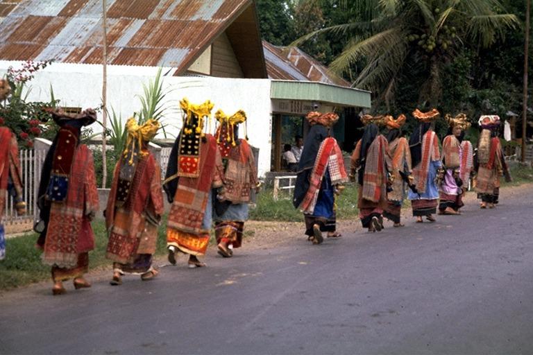 Minangkabau women in traditional clothing and headdresses formed in the shape of water buffalo horns