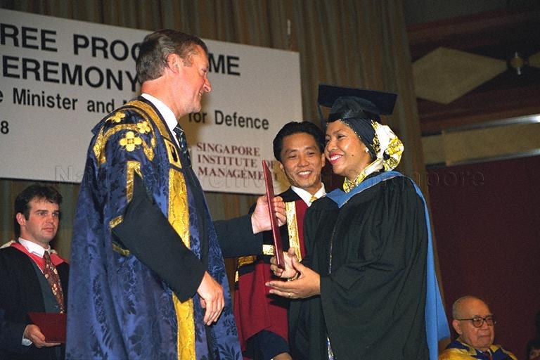 Vice-Chancellor of Open University, United Kingdom (OUUK) Sir John Daniel presenting graduand with degree at inaugural graduation ceremony of the Open University Degree Programme (OUDP) at Westin Stamford. The OUDP was run by Singapore Institute of Management (SIM) in tie-up with OUUK. In 2002, the OUDP was renamed SIM Open University Centre (SIM-OUC) when OUUK granted SIM accreditation status. SIM-OUC eventually evolved to become UniSIM in 2005.