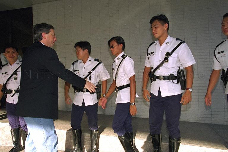 Prime Minister of Luxembourg Jean-Claude Juncker shaking hands with traffic police officers during his departure at Singapore Airport Terminal 2