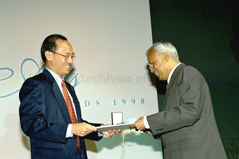 Minister for Information and the Arts and Second Minister for Trade and Industry Brigadier-General George Yeo Yong-Boon presenting medallion and certificate to Cultural Medallion (Literature) recipient Rama Kannabiran during National Arts Council's awards presentation ceremony at Island Ballroom, Shangri-La Hotel