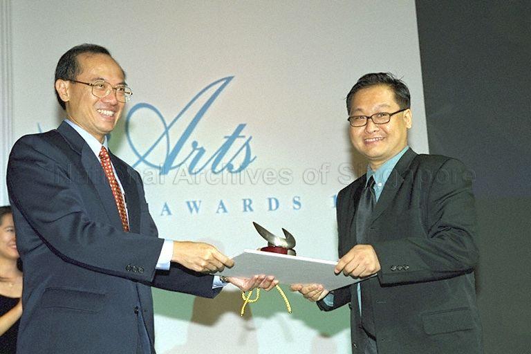 Minister for Information and the Arts and Second Minister for Trade and Industry Brigadier-General George Yeo Yong-Boon presenting trophy and certificate to Young Artist (Theatre) award recipient Alvin Tan Cheong Kheng during National Arts Council's awards presentation ceremony at Island Ballroom, Shangri-La Hotel
