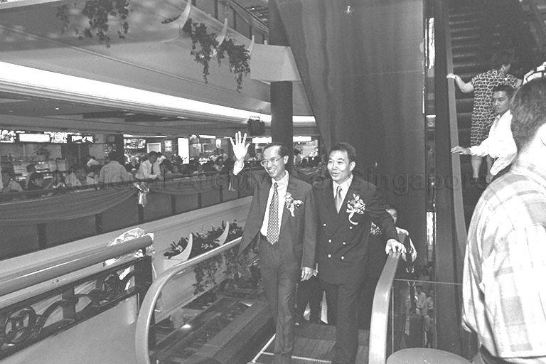 Guest of honour Minister for Information and the Arts and Second Minister for Trade and Industry Brigadier-General George Yeo Yong-Boon accompanied by Managing Director of Wah Khiaw Developments Private Limited Tan Seng Ong (right) touring China Square Food Centre after its official opening 