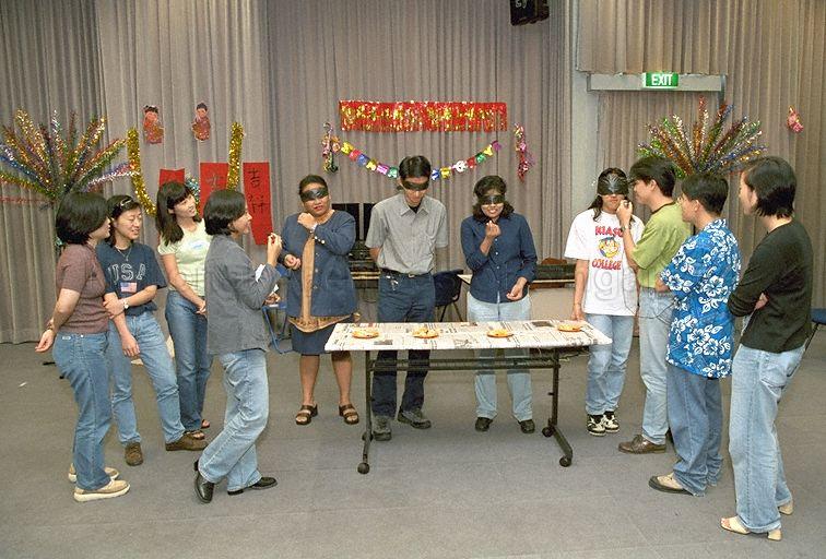 Game being played during Hari Raya Puasa and Chinese New Year celebrations at Government Press Centre, Ministry of Information and the Arts, Port of Singapore Authority (PSA) Building. In 1999, Hari Raya Puasa was on 19 Jan and Chinese New Year was on 16 Feb.