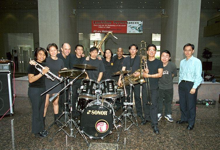 Members of National University of Singapore (NUS) Jazz Band posing for a group photograph during lunchtime performance at Port of Singapore Authority (PSA) Building atrium
