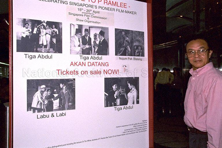Press conference on "A Tribute to P Ramlee" by Singapore Film Commission at Shaw Centre - Attendee at press conference posing infront of publicity poster