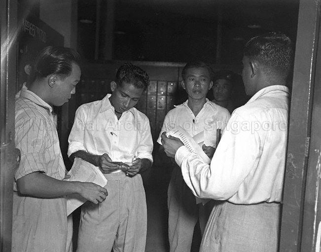 Members of Singapore Post and Telegraph Uniformed Staff Union in discussion during a 13-day postal strike in negotiation for fairer pay