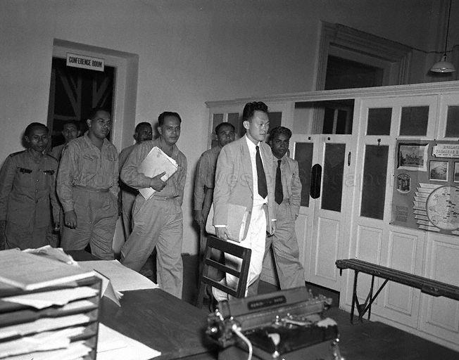 Singapore lawyer Lee Kuan Yew, who is counsel for Singapore Post and Telegraph Uniformed Staff Union, leaving the conference room at the Colonial Secretary's Office with Union's executive committee members