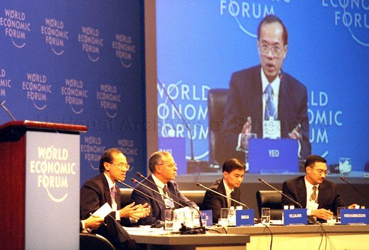Singapore Minister for Trade and Industry Brigadier-General George Yeo Yong-Boon speaking at closing plenary session of World Economic Forum (WEF)'s East Asia Economic Summit 1999 held in Singapore International Convention and Exhibition Centre (SICEC) Ballroom. Looking on are panel members WEF Managing Director Claude Smadja (second from left), Abhisit Vejjajiva of Thailand and Dato Seri Hishammuddin bin Tun Hussein of Malaysia.