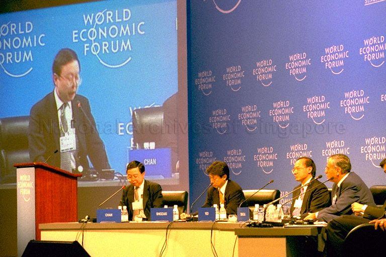 Mr Ronnie C Chan (left) of Hong Kong speaking at closing plenary session of World Economic Forum (WEF)'s East Asia Economic Summit 1999 held in Singapore International Convention and Exhibition Centre (SICEC) Ballroom. Looking on are panel members Yasuhisa Shiozaki of Japan (second from left), Singapore Minister for Trade and Industry Brigadier-General George Yeo Yong-Boon and WEF Managing Director Claude Smadja.