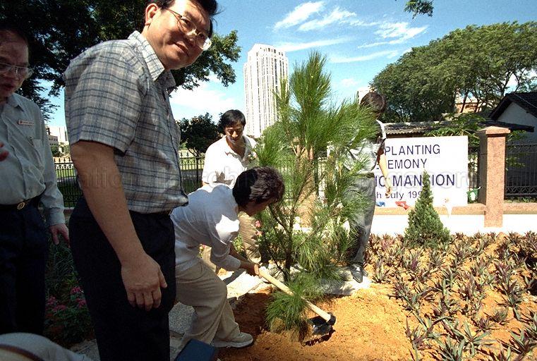 Member of Parliament for Kreta Ayer-Tanglin Group Representation Constituency (GRC) Dr Lily Neo (back to camera) planting a sapling at the grounds of Pacific Mansion located at River Valley Close when she accompanies Minister for Trade and Industry Brigadier-General George Yeo Yong-Boon on a tour of Kim Seng Division of Kreta Ayer-Tanglin &nbsp;GRC