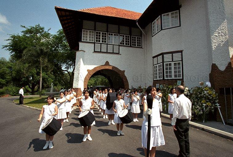 Band from Nanyang Girls' High School playing for funeral of Mrs Ong Siew May, wife of President Ong Teng Cheong, at 1 Dalvey Estate. Mrs Ong, who passed away on 30 July 1999, was a former student of the school.