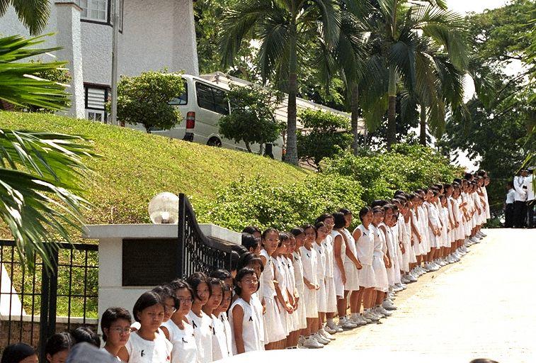 Students from Nanyang Girls' High School lining up driveway of residence of President Ong Teng Cheong at 1 Dalvey Estate, during funeral of Mrs Ong Siew May. Mrs Ong, who passed away on 30 July 1999, was a former student of the school.