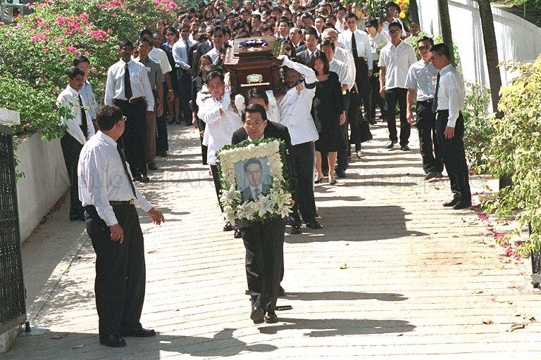 The late former President Ong Teng Cheong's son, Tze Guan (with portrait) leading the funeral procession from 1, Dalvey Estate