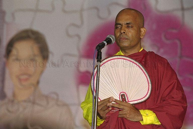 Buddhist monk praying at Inter-faith Prayer for the Millennium and Charity Dinner at Singapore Expo, 1 Expo Drive. President S R Nathan and the First Lady are guests-of-honour at this event.