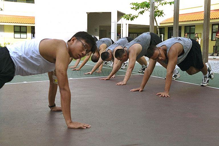 Singapore Armed Forces (SAF) recruits doing pushups; photo taken during inaugural visit of past and present members of Advisory Council on Community Relations in Defence (Accord) to SAF Basic Military Training Centre on Pulau Tekong. Visit was hosted by Minister of State for Defence David Lim.