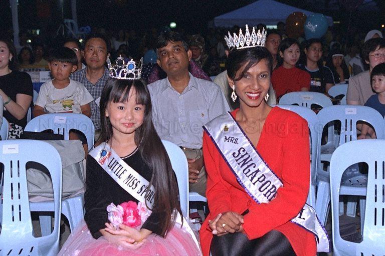 The reigning Little Miss Singapore Elizabeth Quek and Mrs Singapore International Sharmini Anandam attending launch of Sing Singapore 2000 at Music Street at Orchard Mass Rapid Transit (MRT) station park. Sing Singapore is held every two years to discover and promote original songs written by Singaporeans for Singaporeans. The five-month-long campaign includes singing competitions, free public concerts and music video launches. Minister of State for Defence and Minister of State for Information and the Arts David T E Lim is guest of honour at the launch.