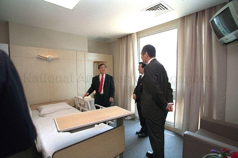 Deputy Prime Minister and Minister for Finance Lee Hsien Loong (back to camera) being briefed by Executive Chairman of Raffles Medical Group Dr Loo Choon Yong while touring patient room in Raffles Hospital during opening of the private hospital at North Bridge Road